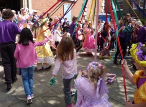 Chorkdren dancing around tte maypole