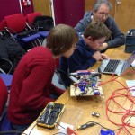 three compouter clib members programming robot