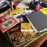 books and papers piled on the table