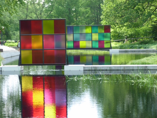 panels of coloured Chihuly glass squares reflected in water squares