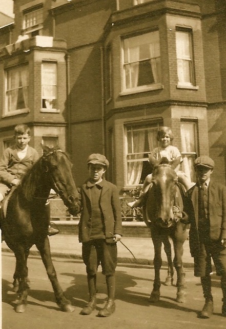 Two children riding ponies